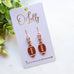 Gold Football Dangle Earrings with Cubic Zirconia Accent “Blitz”