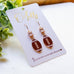Gold Football Dangle Earrings with Cubic Zirconia Accent “Blitz”